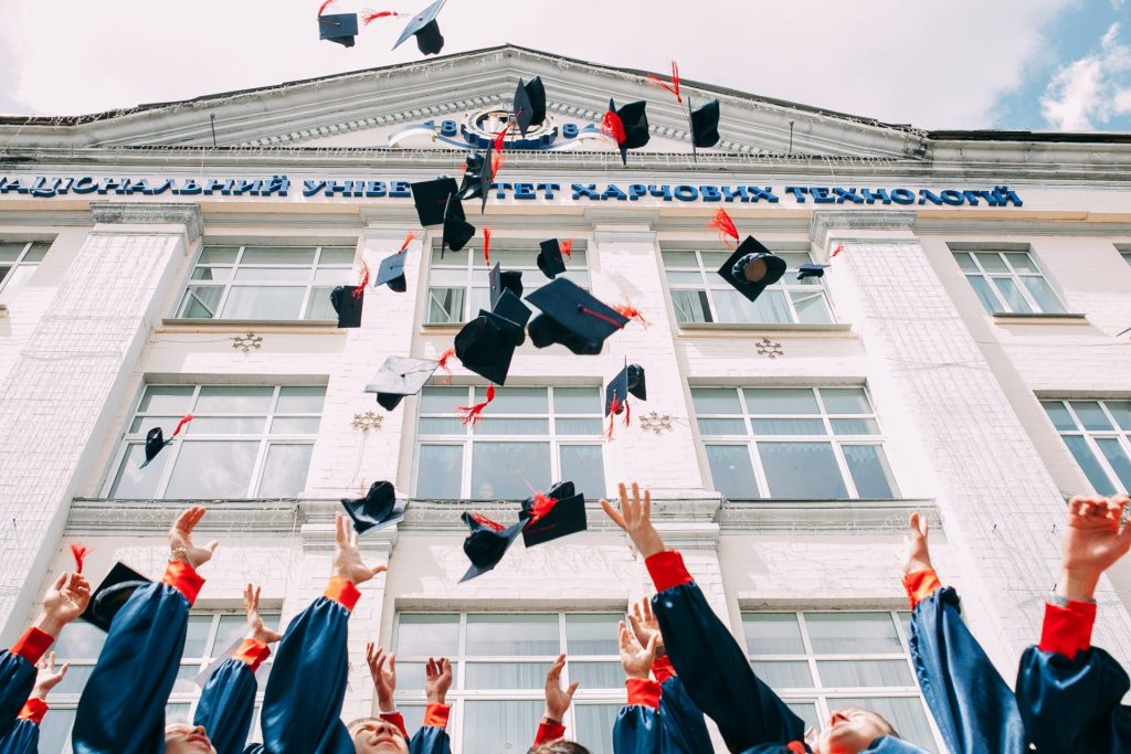 university students throws graduation hat